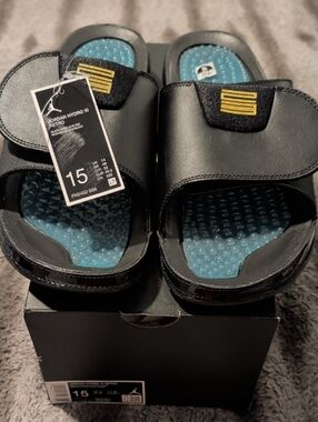 Jordan Black Slides with Blue Textured Footbed and Gold Accent
